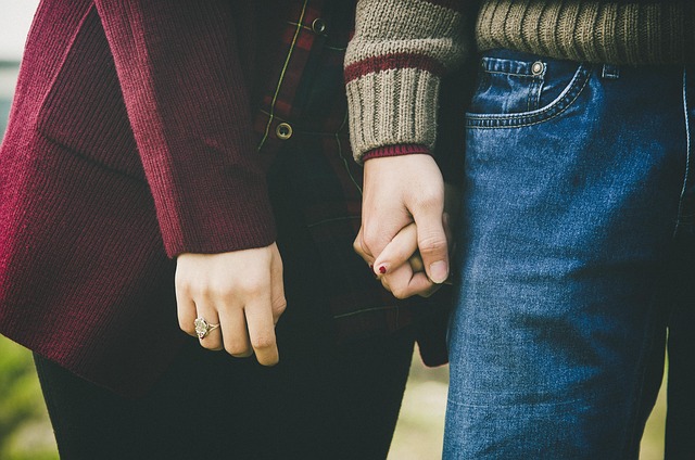 Hand holding a custom-engraved pen with a blurred office background