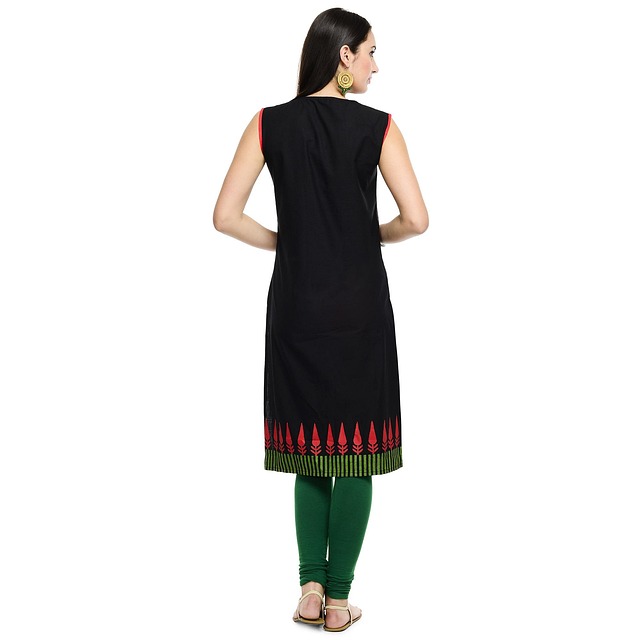 Woman wearing a contemporary fusion outfit with a long kurta and wide-leg pants