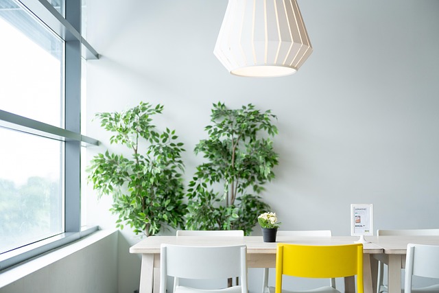 A small minimalist living room utilizing wall-mounted shelving and a large mirror to maximize space
